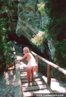 Teen blonde shows her shaved pussy outdoor