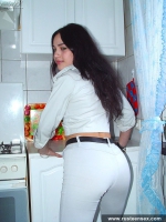 Russian teen brunette undressing in the kitchen