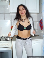 Russian teen brunette undressing in the kitchen