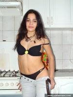 Russian teen brunette undressing in the kitchen
