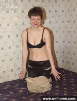 Mature brunette posing naked with a scarf