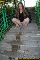 Pissing on outdoor concrete ladder