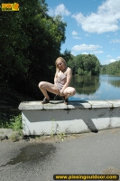 Outdoor pissing on embankment in summer day