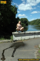 Outdoor pissing on embankment in summer day