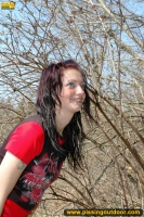 Outdoor pissing on the dry grass on a pond shore