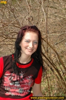 Outdoor pissing on the dry grass on a pond shore
