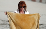 Beautiful Marg Helgenberger wearing black bikini.