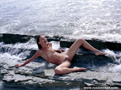 Russian teen brunette poses naked in the sea surf - N