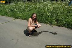 Teen girl pissing on asphalt outdoor - N