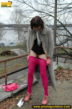 MILF brunette pissing on concrete lookout - N