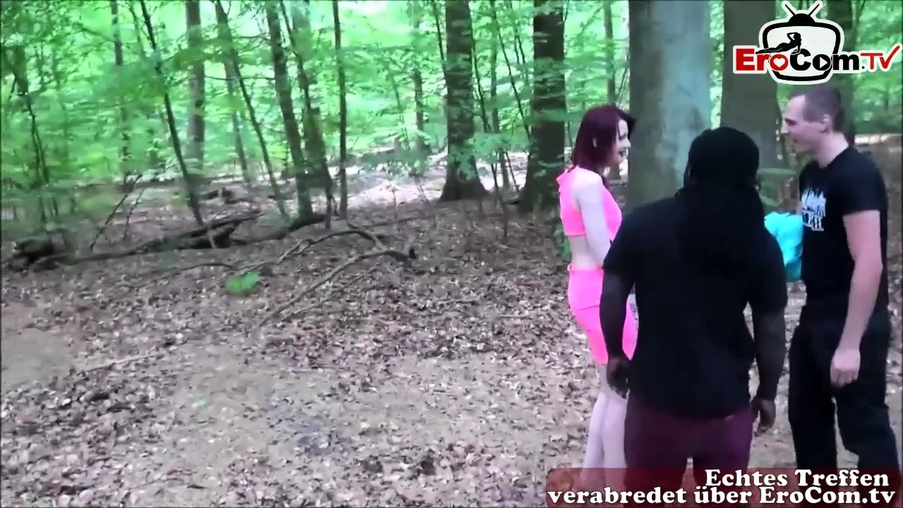 Slim redhead having a threesome outdoors
