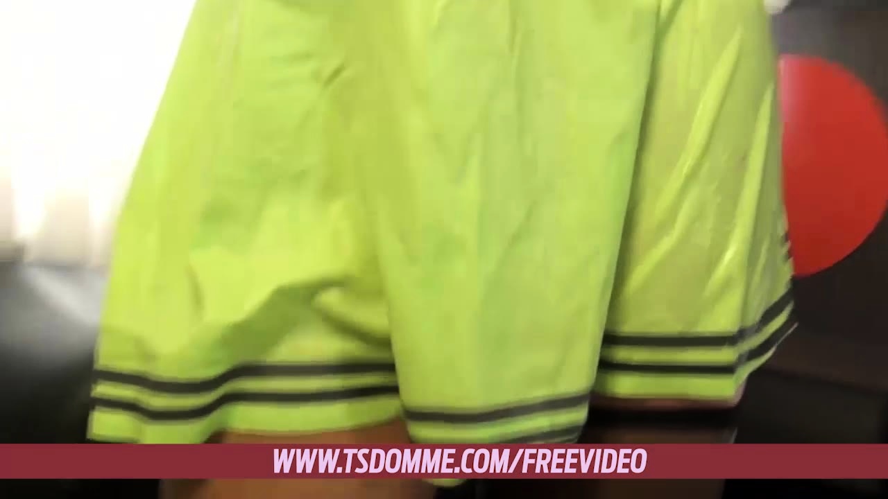 Chubby blonde shemale in green latex dress strokes her big