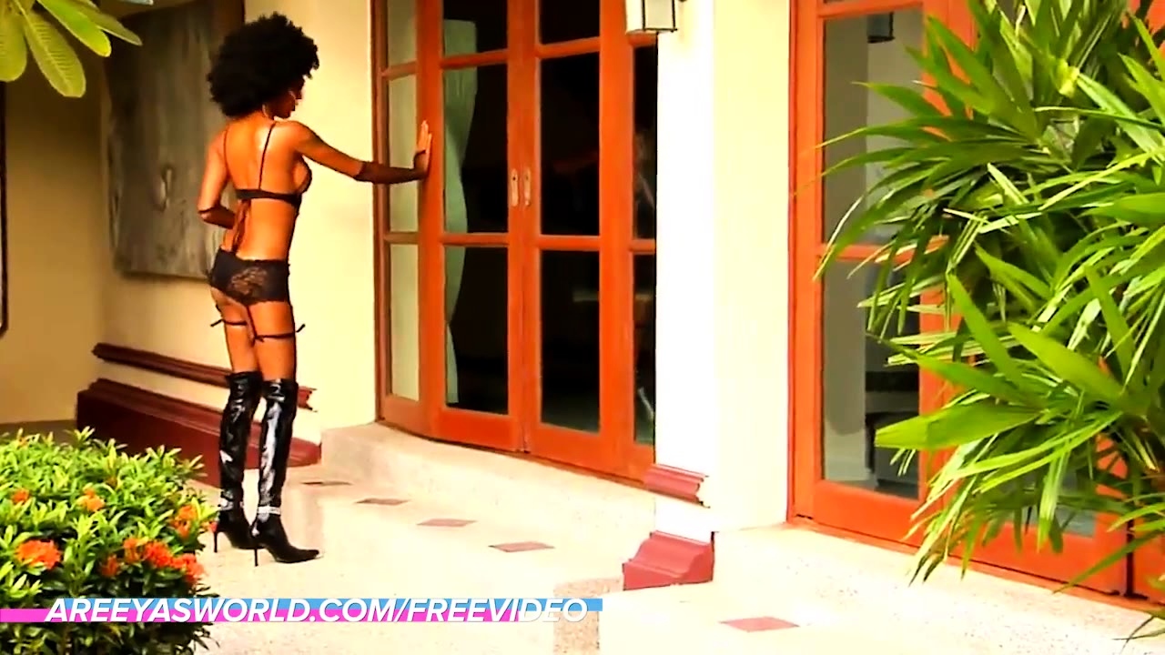 Dark skinned ladyboy with an afro teases with her shaved
