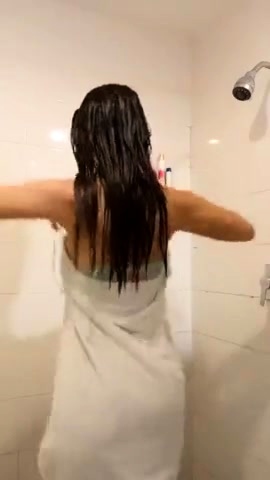 Stunning brunette takes a shower in her lingerie